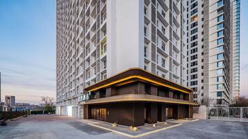 A hotel with a modern facade, large windows, and a spacious entrance area.
