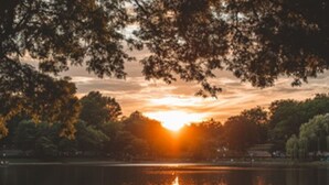 Two people sitting by a lake at sunset. - Lakefront 4 Bedrooms - 2 Private Lodge Suites, Sleeps 12, Free Kayaks, Hot Tubs! (Angola)