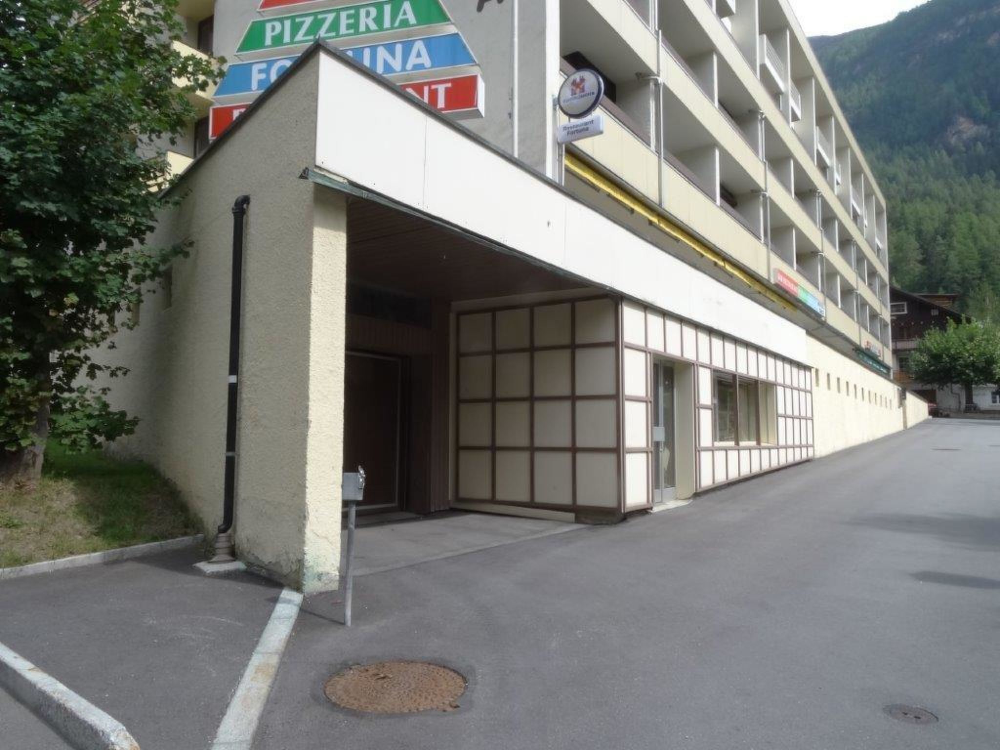 A building with a sign for a pizzeria and a restaurant.