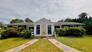 A single-story house with a front porch, a small garden, and a pathway leading to the entrance. - 2Bed 1Bath- ½ Mile walk to Mayflower, central A/C, CLEAN w/ washer/dryer (Dennis)