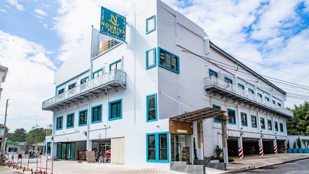 A two-story building with a sign reading 'NOURIVA PLACE' and a covered entrance. - Nouriva Place Bangkok (Bangkok)