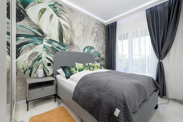A cozy bedroom with a comfortable double bed and elegant botanical décor. The perfect place to enjoy a peaceful night's sleep.