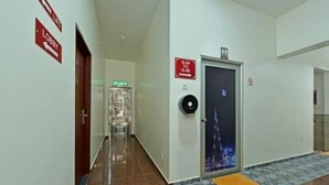 A hotel corridor with a door marked 'G-04 TO G-08', a fire alarm, and a 'Lobby' sign. - RS Hotel (Johor Bahru)