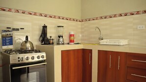 A kitchen with a stove, oven, and cabinets.