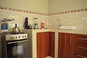 A kitchen with a stove, oven, and cabinets.