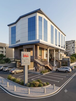 A modern hotel building with a sign for 'HOTEL DEV CORPORATE' and 'NAYAA'. - Hotel Dev Corporate Ahmedabad  (Ahmedabad)