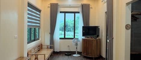 Deluxe Double Room, Patio, Garden View | Minibar, in-room safe, desk, laptop workspace