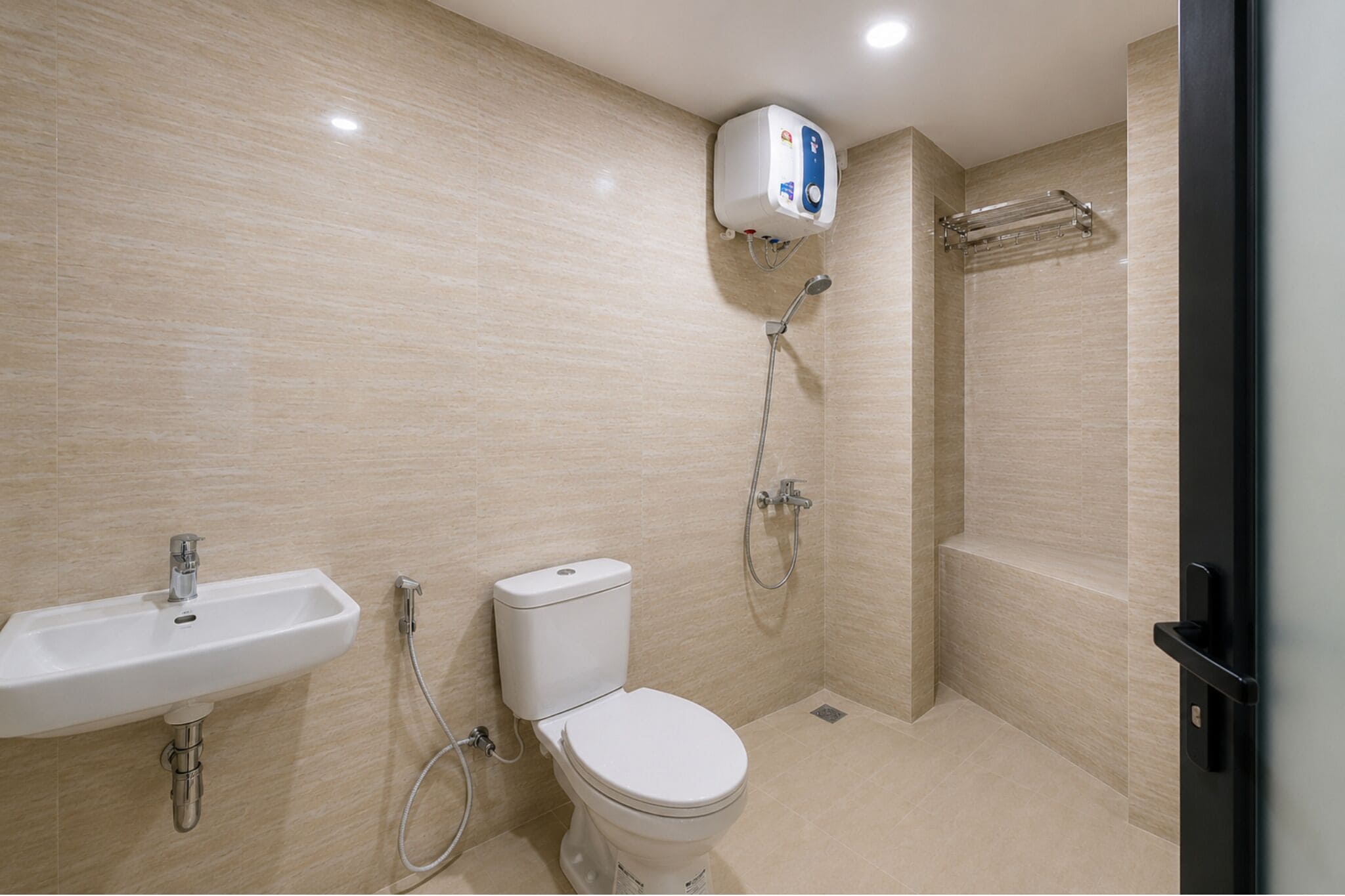 A bathroom with a sink, toilet, and shower.