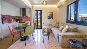 A modern living space with a kitchen, dining area, and seating area. - Noble Heraklion Suites, Terra Suite in Crete (Nea Alikarnassos)