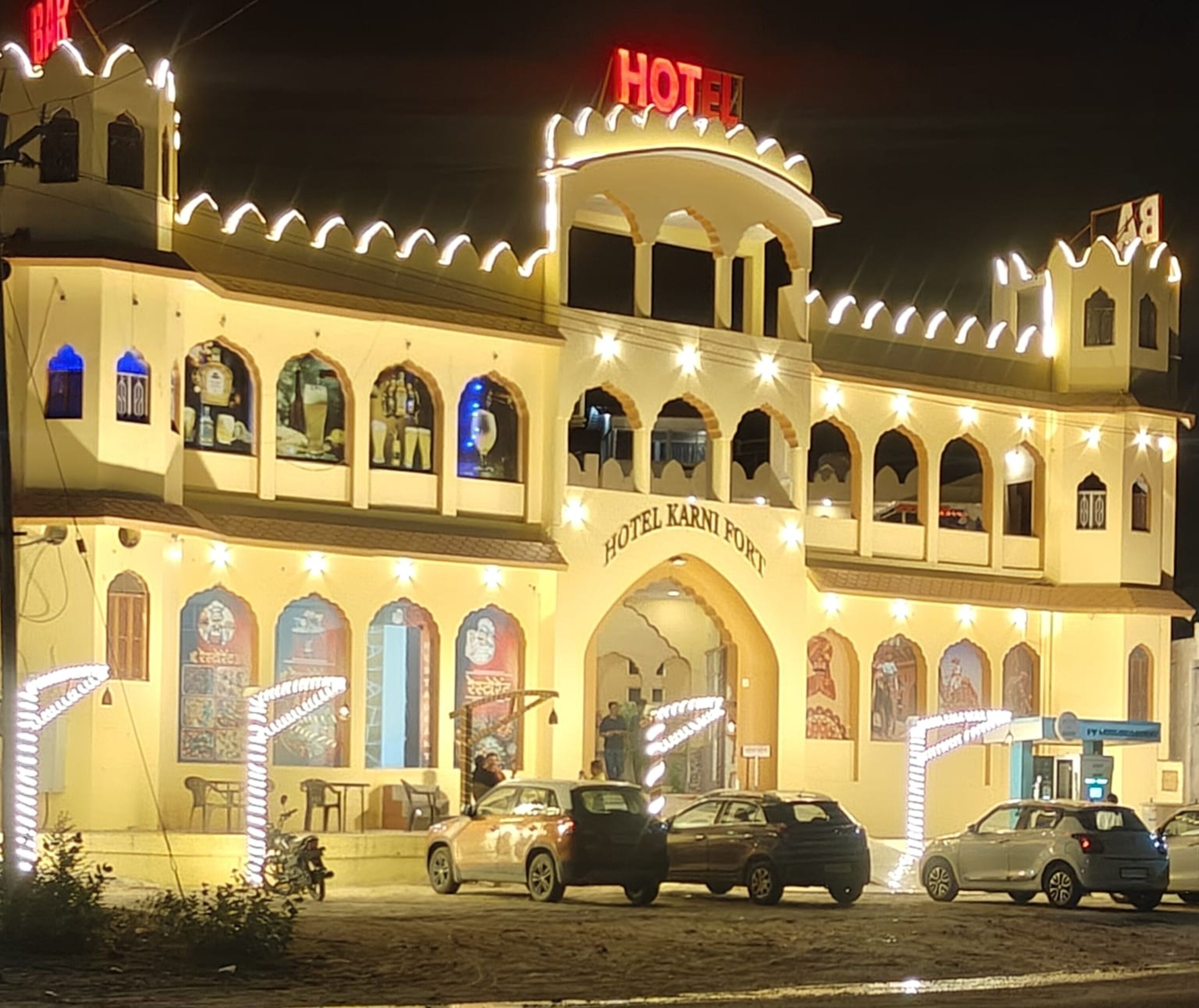 A building with a sign reading 'HOTEL KARNI FORT' and multiple windows.