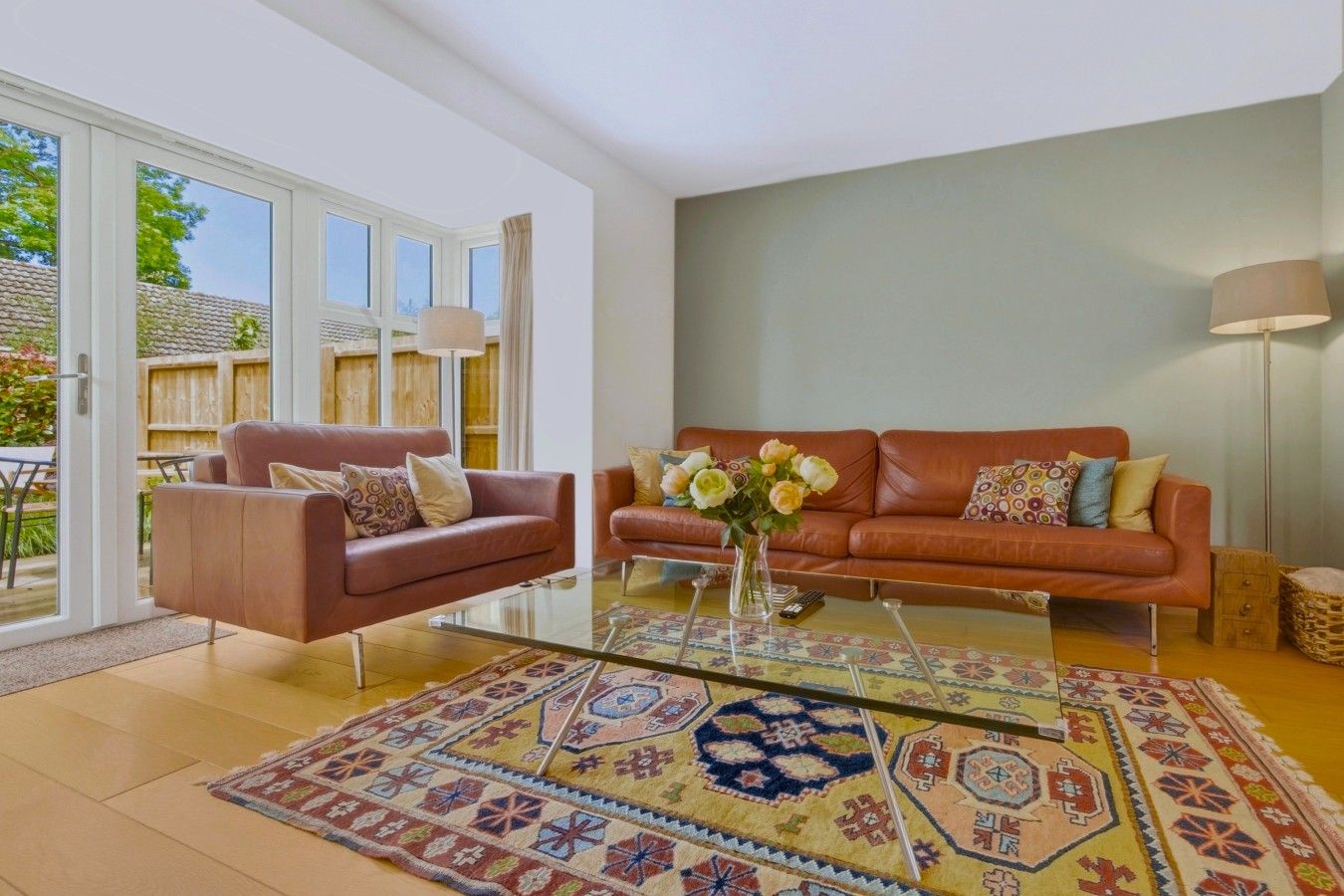A living room with two sofas, a coffee table, and a patterned rug.