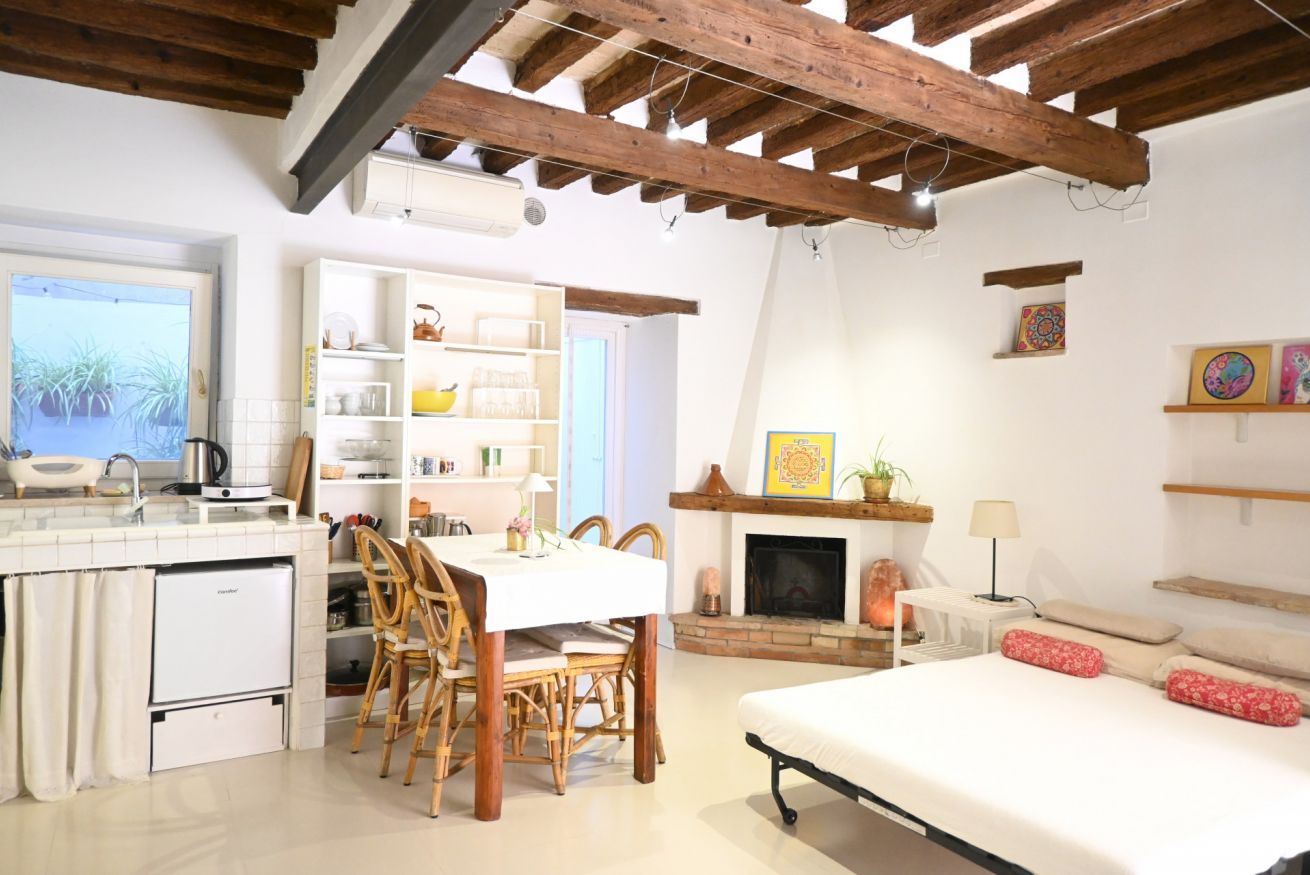 A compact living space with a kitchen, dining area, and a bedroom.