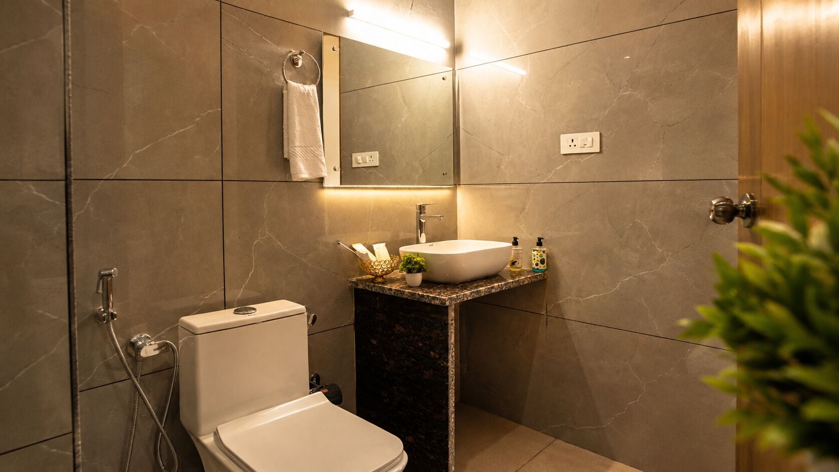 A modern bathroom with a toilet, sink, and shower.