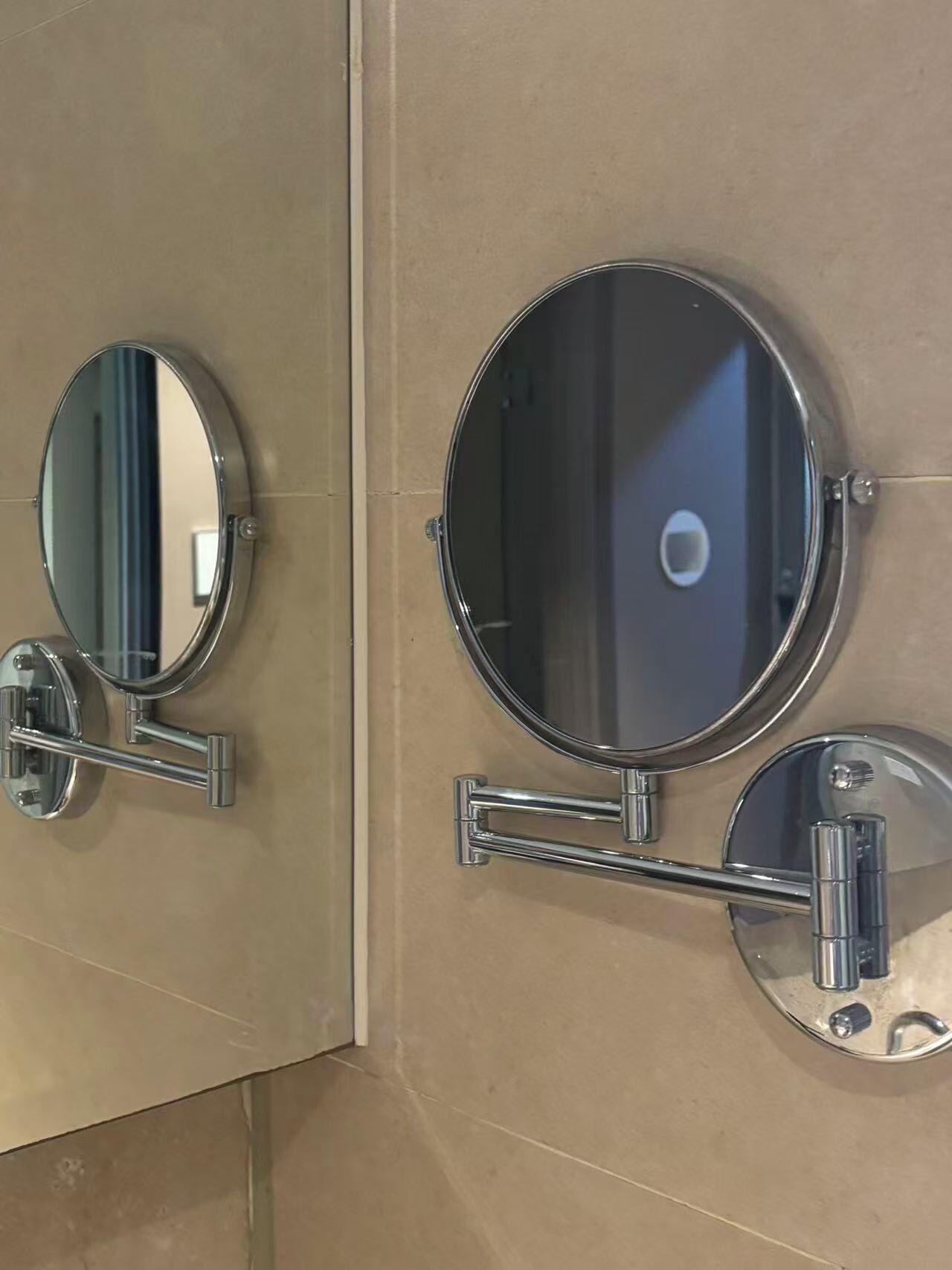 Two wall-mounted mirrors with chrome frames and a chrome handle.