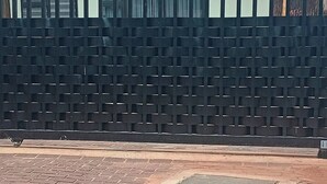 A building with a patterned facade, a paved area in front, and a green roof. - The Corner Nest at Constantia Kloof with backup Wi-Fi (Roodepoort)