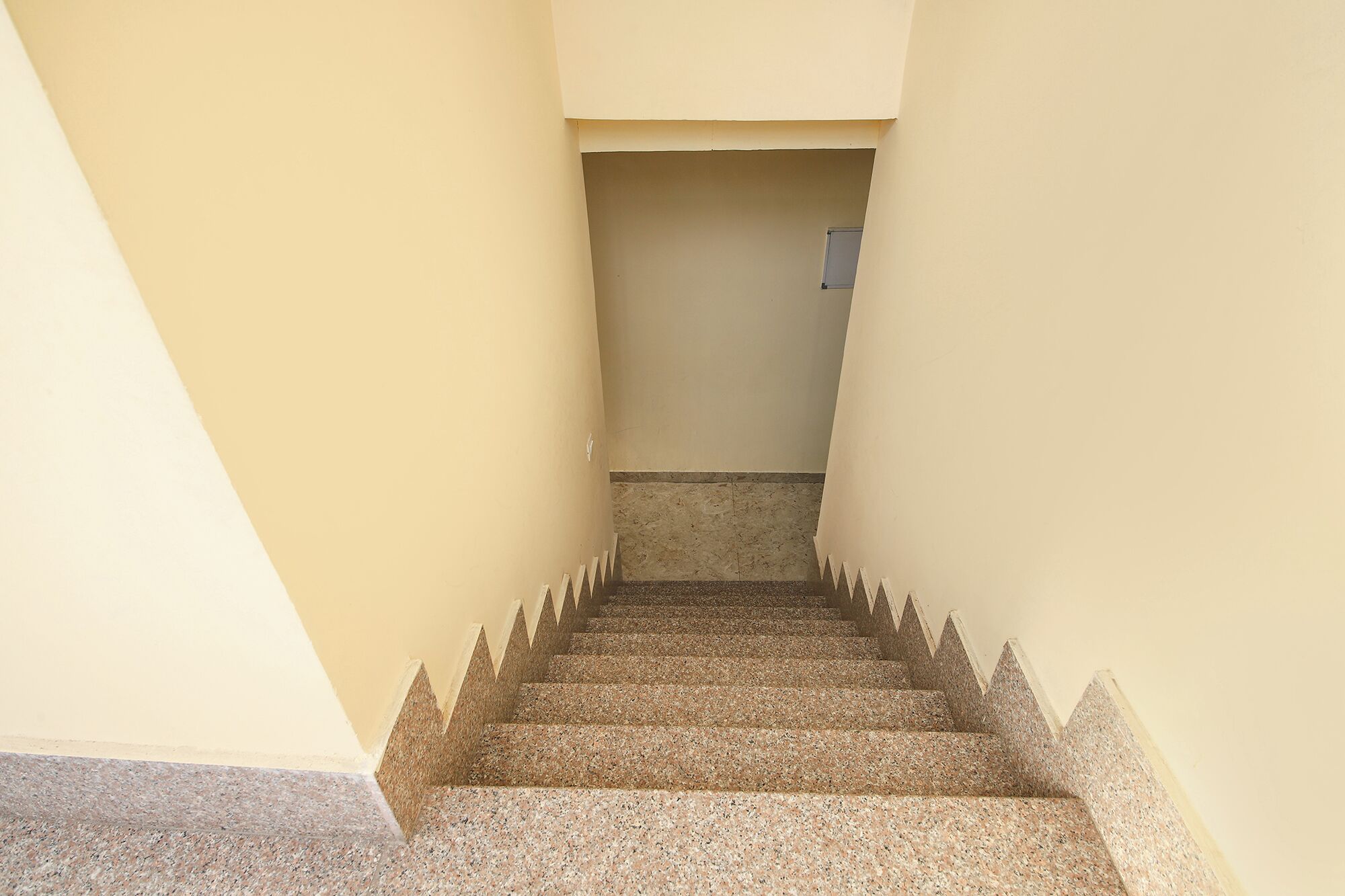 A staircase with a handrail leading to a landing.