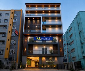 A multi-story hotel with a modern facade, a prominent sign for 'fab hotels', and a 'Midori Inn Premium Stay' sign at the entrance. - FabHotel Midori Inn - HITECH City (Hyderabad)