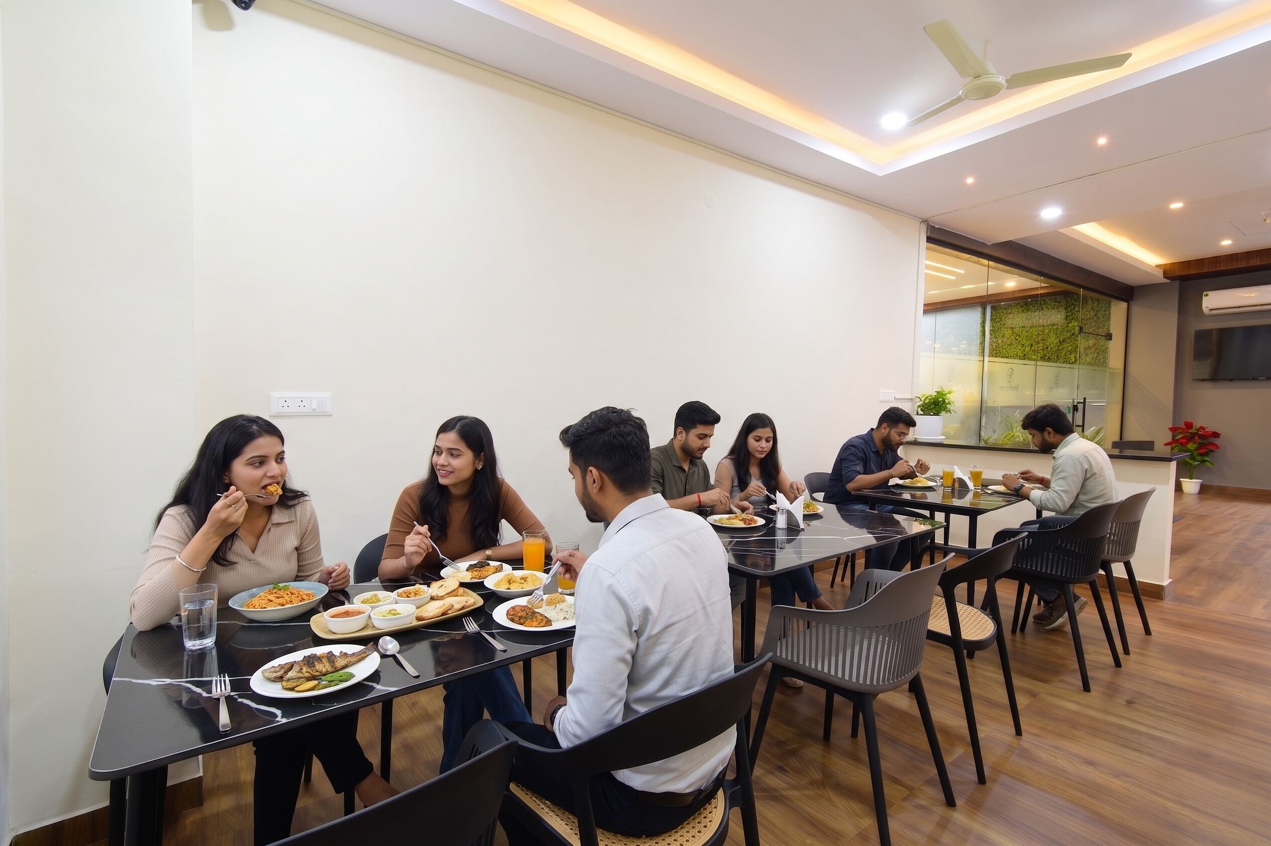 A dining area with multiple tables and chairs, a ceiling fan, and a wall-mounted air conditioning unit.
