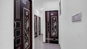 A hallway with doors numbered 253 and 254, featuring decorative patterns. - FabHotel Platinum Pavillion Residency (Nashik)