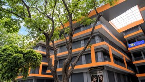 A multi-story building with balconies, a spa salon, and a sign for 'fabHOTELS'. - FabHotel Platinum Pavillion Residency (Nashik)