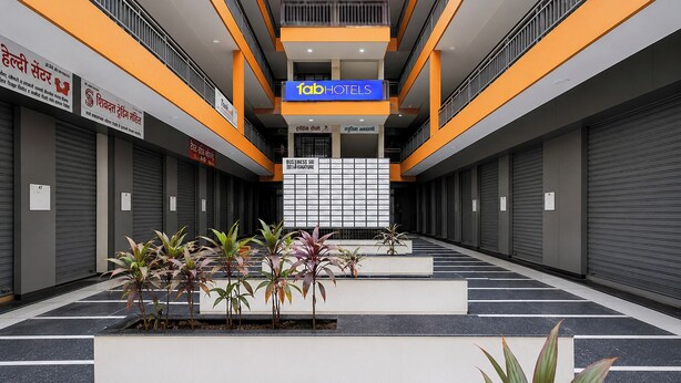 A modern hotel interior with a central atrium, a visible elevator, and a sign for '1abHOTELS'. - FabHotel Platinum Pavillion Residency (Nashik)