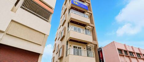 A multi-story hotel with a prominent blue sign indicating it is a Tab Hotel.