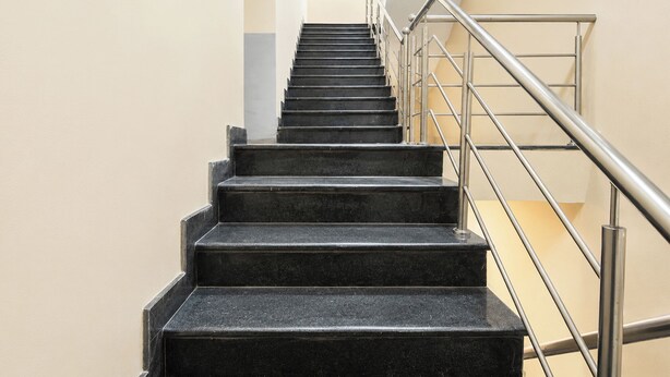 A staircase with black steps and metal railings. - Fabhotel Ak Acacia Jazz Club (Jaipur)