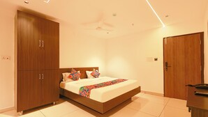 A bedroom with a bed, wardrobe, and a door.
