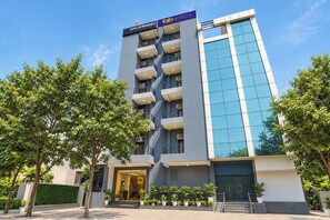 A modern hotel building with a prominent 'Tab Hotels' sign, multiple balconies, and a glass facade. - FabHotel As Residency (Noida)