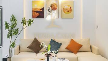 A modern living room with a sofa, a coffee table, and wall art.