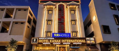 A hotel with a modern facade, luxury rooms, banquet hall, restaurant, and conference hall.