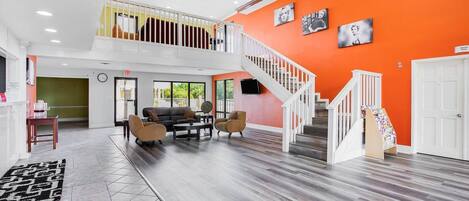 A spacious living area with a staircase, a sofa set, and a coffee table.