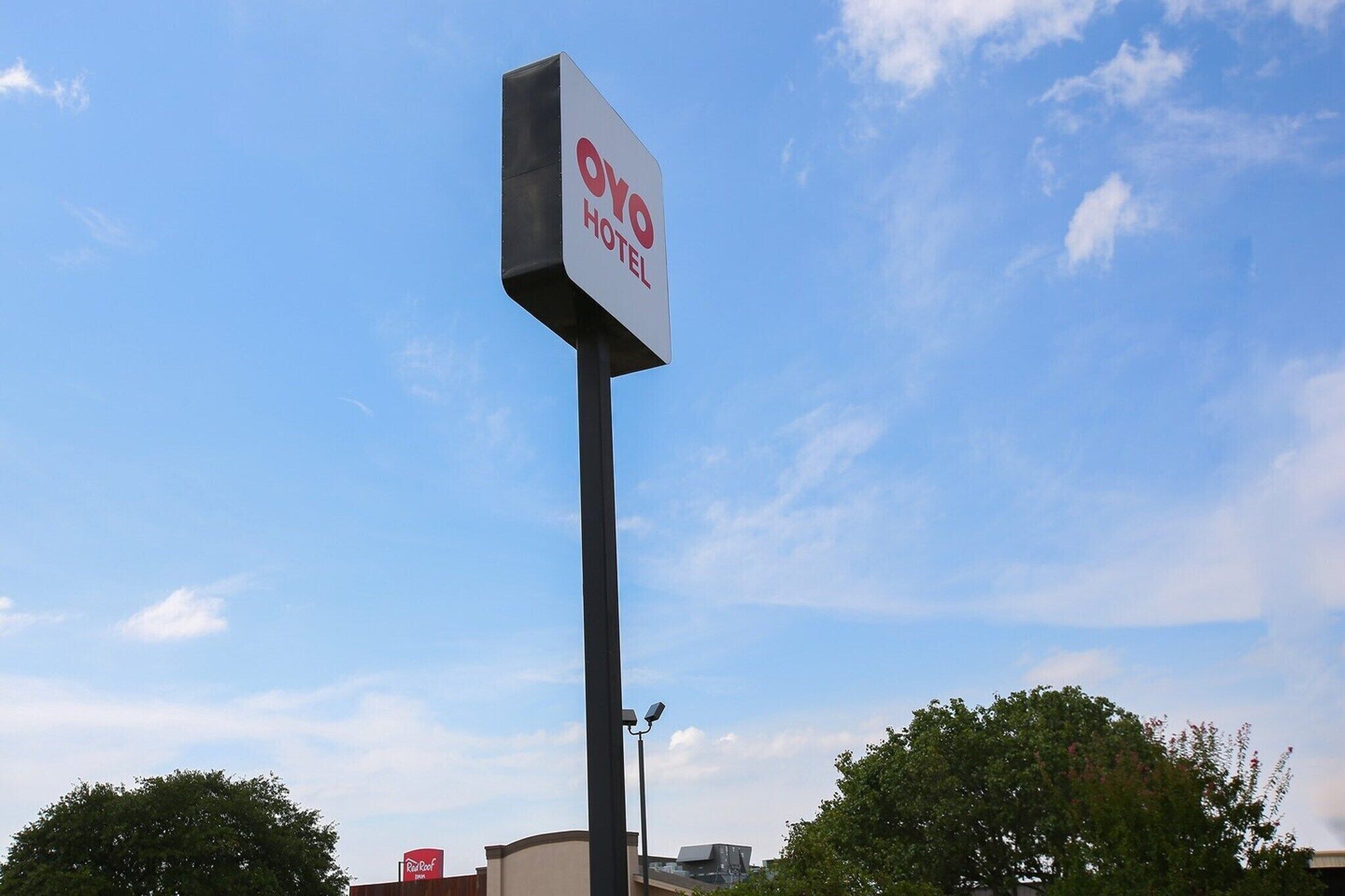 A hotel sign with 'Oyo Hotel' written on it.