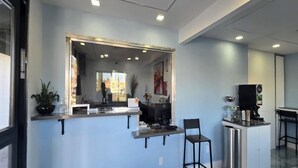 A modern interior with a bar area, a large mirror, and a coffee machine. - King Bed|Walkin|Victorville (Victorville CA)