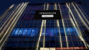 A modern building with a sign reading 'TOWNHOUSE Company-Serviced.' - Saver Double Patparganj Near Max (New Delhi)