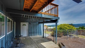 A covered outdoor area with a wooden ceiling, a metal fence, and a view of the landscape. - Quick Hwy Access to Seattle! Mtn-View Apt w/ Yard (Renton)