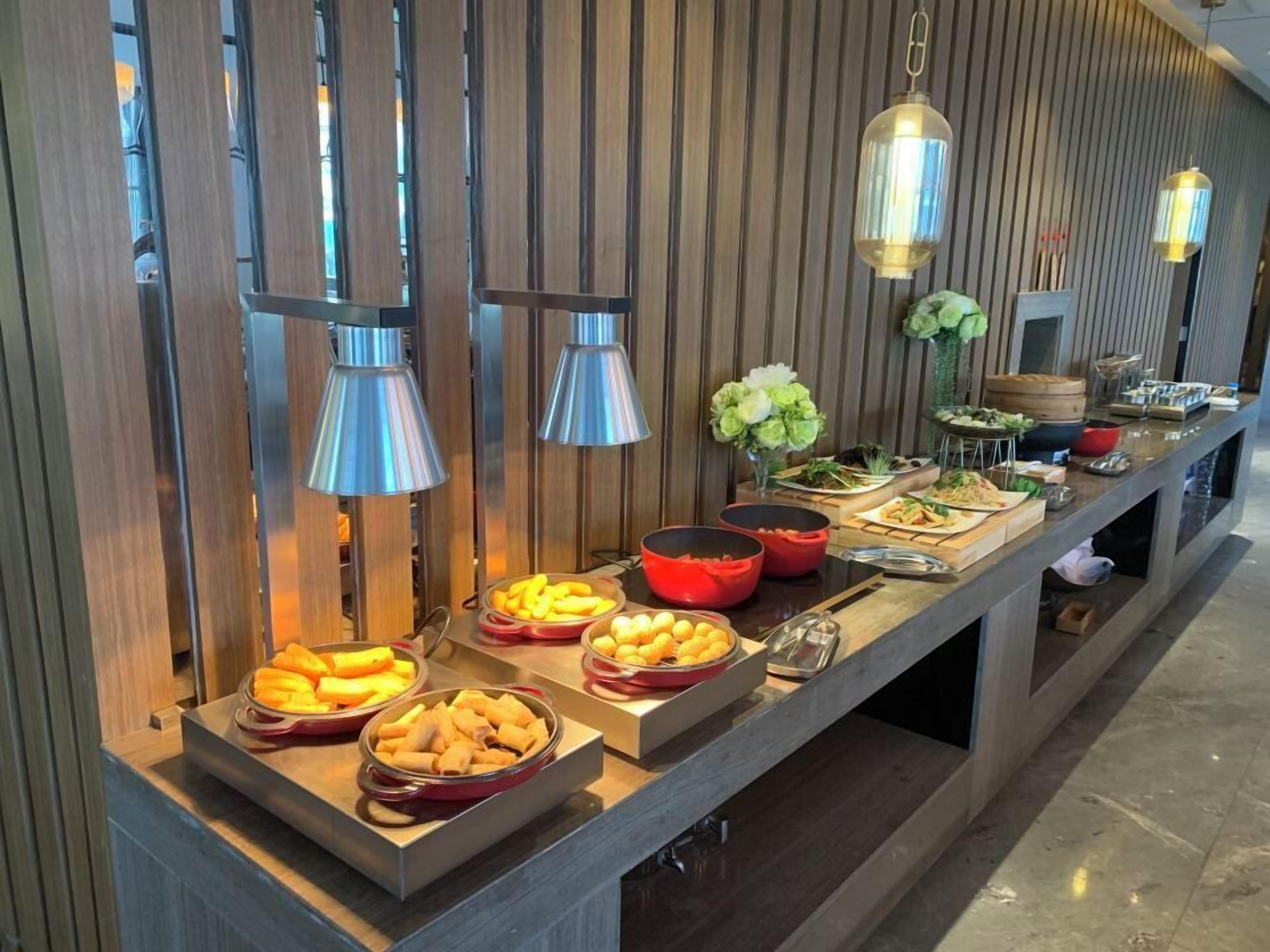 A buffet with various food items and decorative elements.