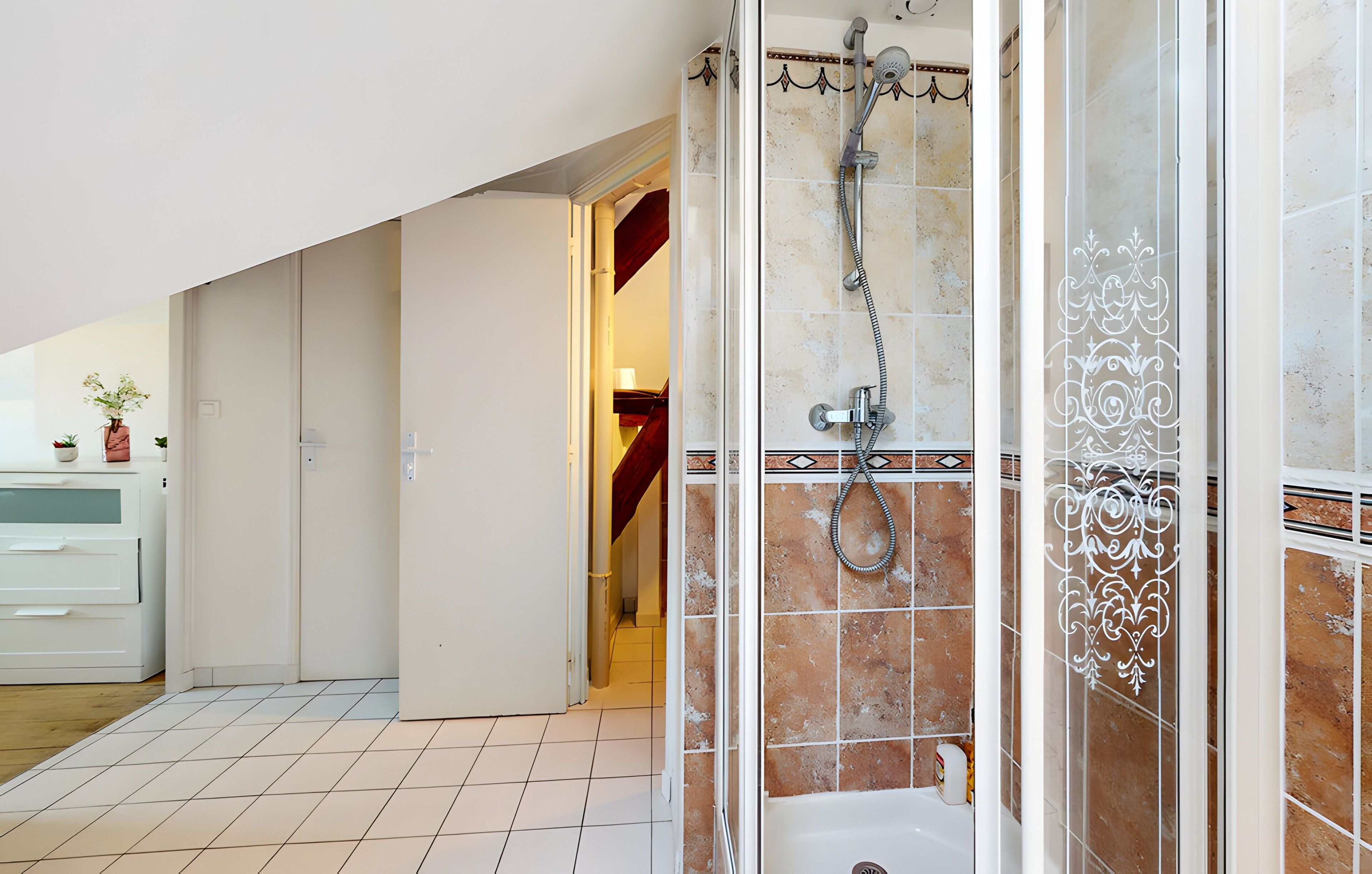 A bathroom with a shower, a toilet, and a sink.