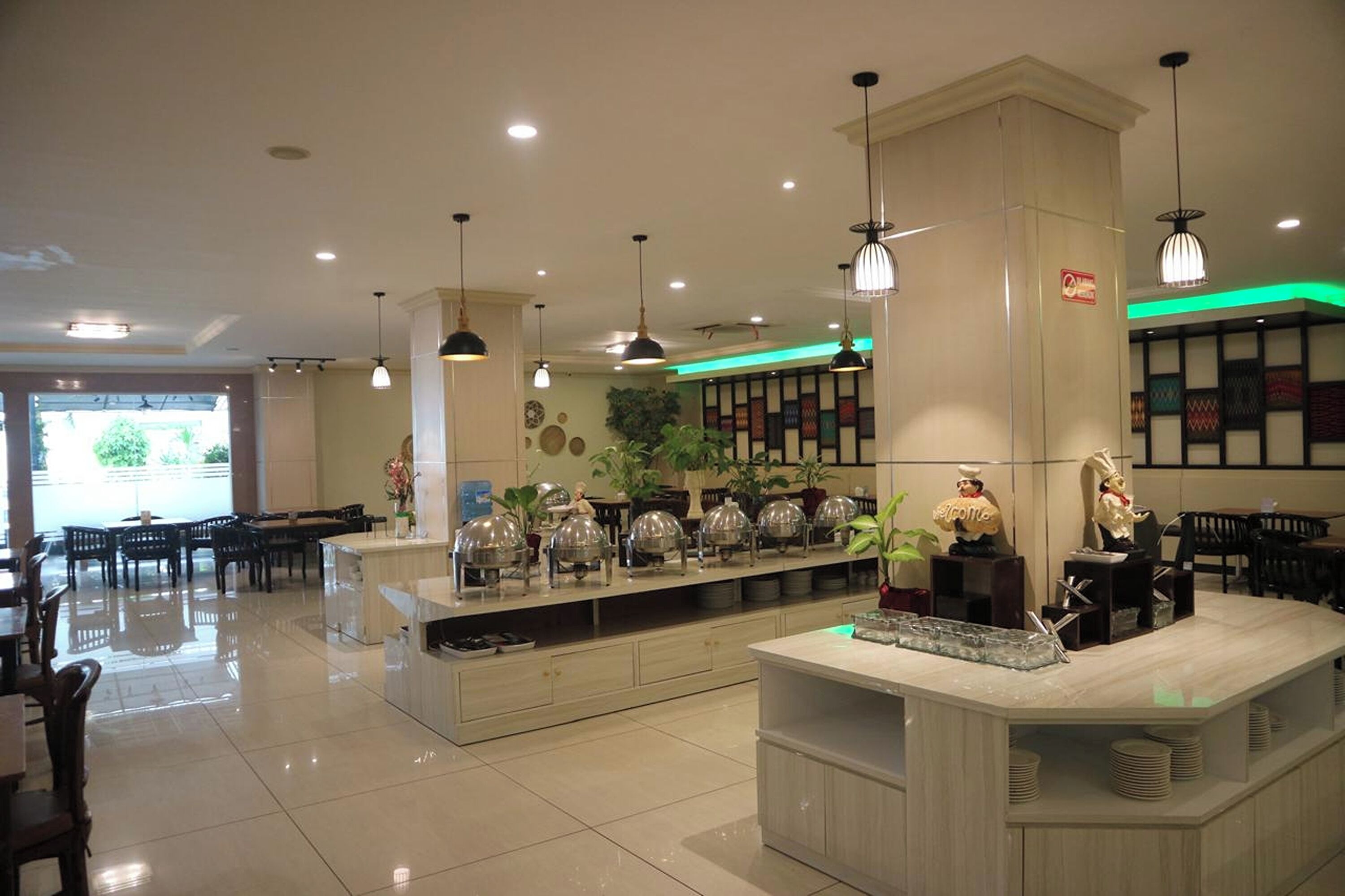 A hotel lobby with a reception desk, seating area, and decorative elements.