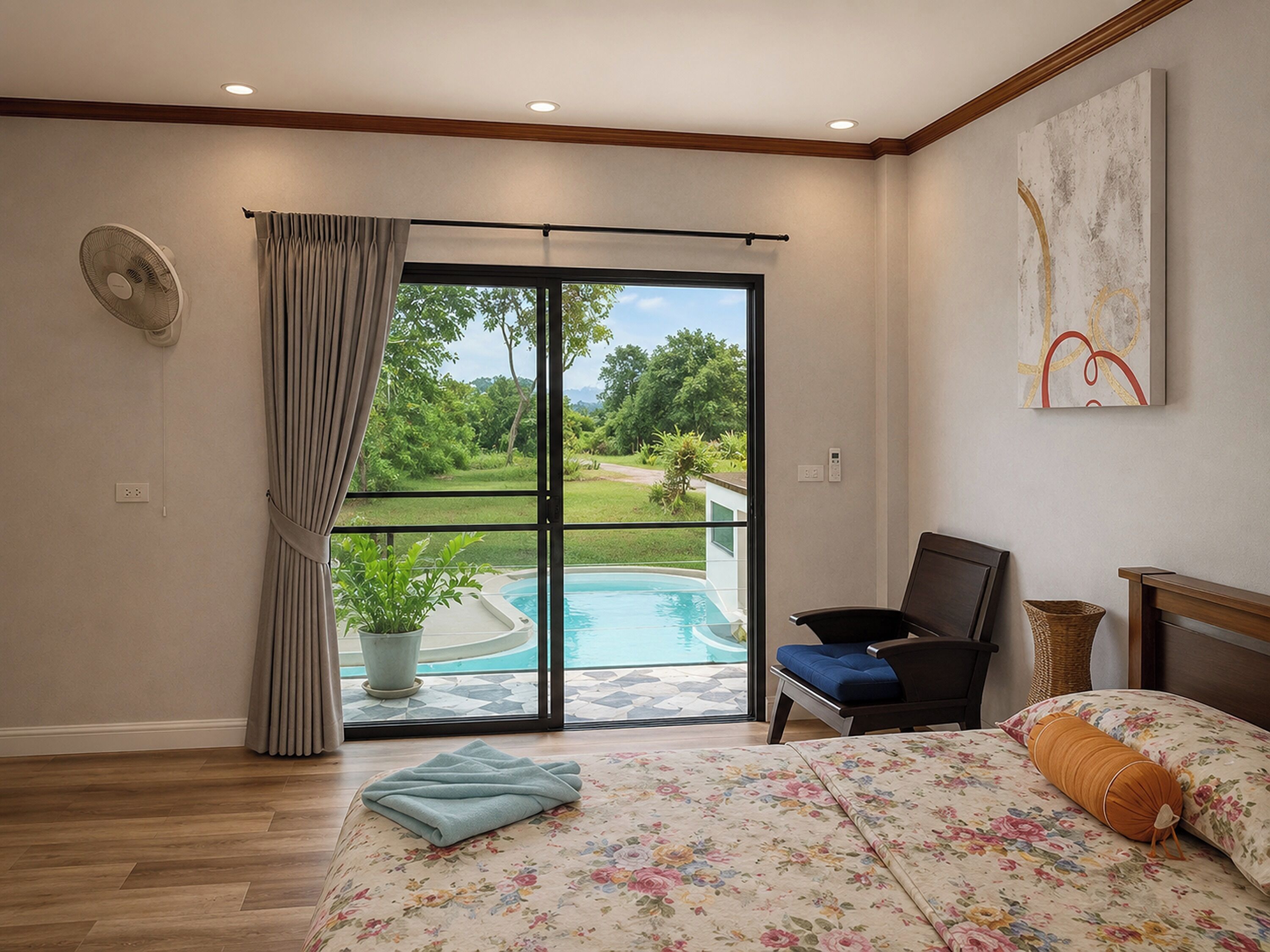 A bedroom with a bed, a chair, a fan, a window with curtains, and a view of a swimming pool.