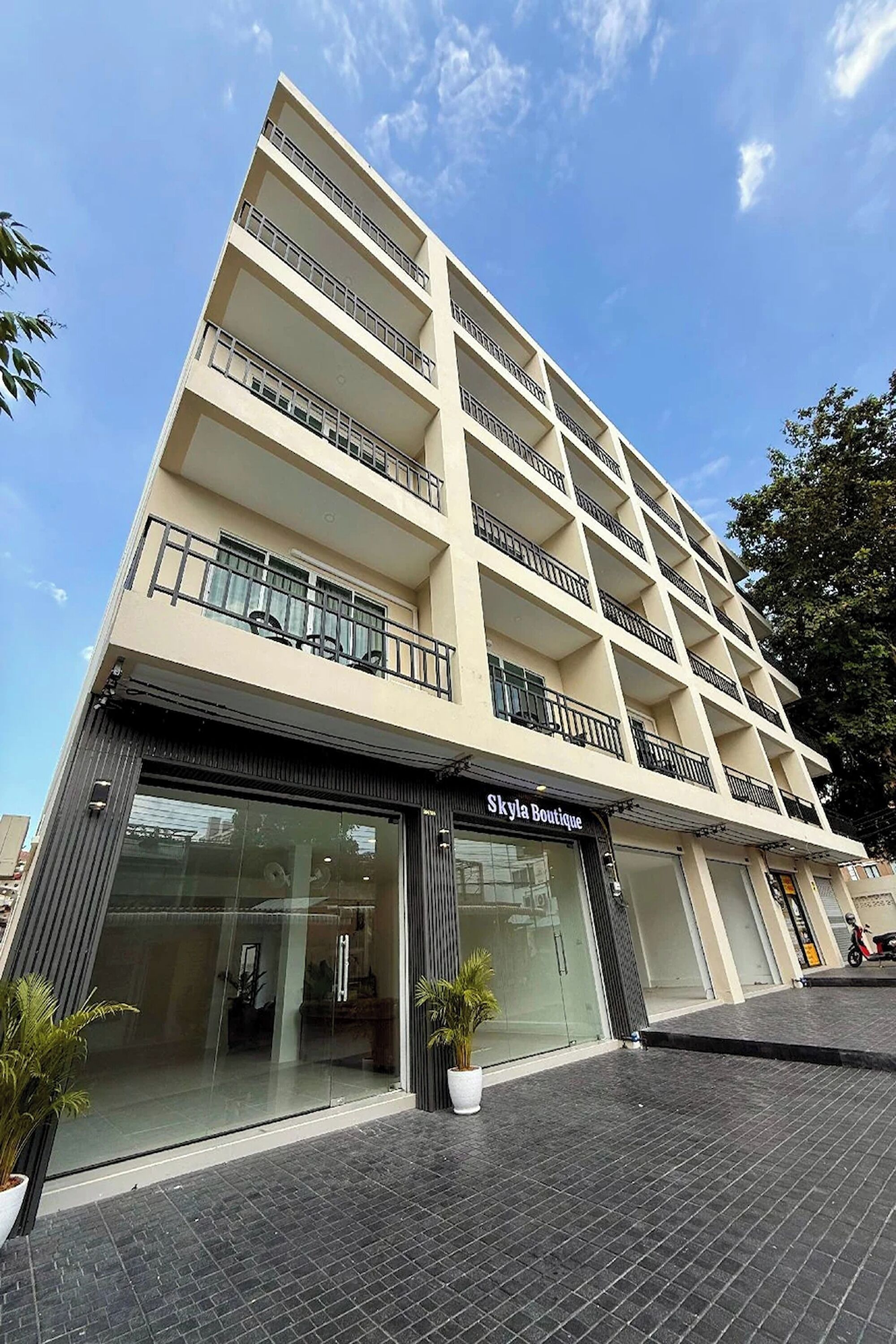 A multi-story building with a storefront labeled 'Skylia Boutique.'