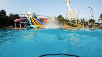 A water park with a water slide, a tower, and a roller coaster.