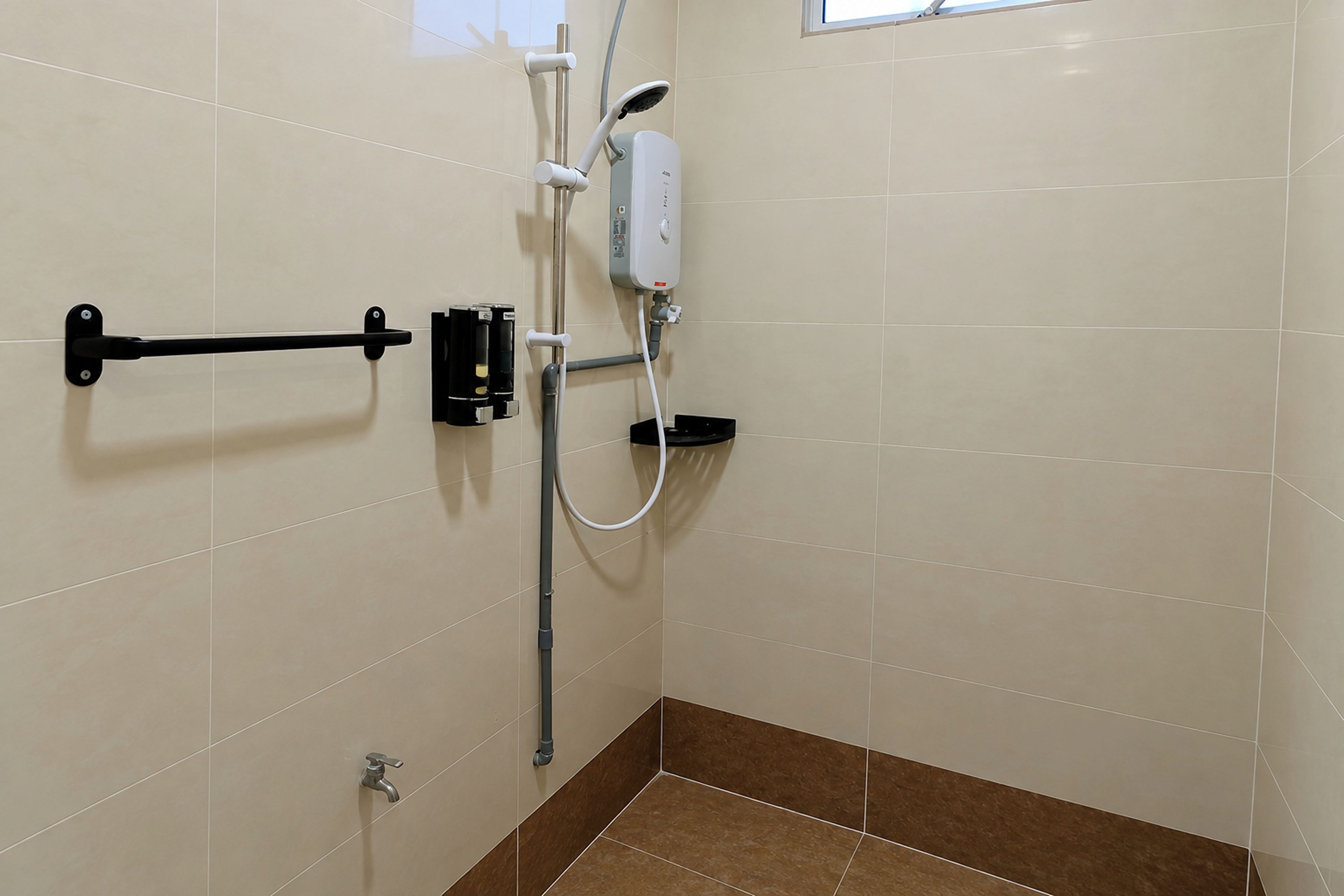 A bathroom with a shower, a towel rack, and a toilet.