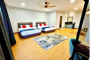 A hotel room with two beds, a ceiling fan, a bathroom with a mirror, and a wooden floor. - Km Barakah Suite Kuala Terengganu (Kuala Terengganu)
