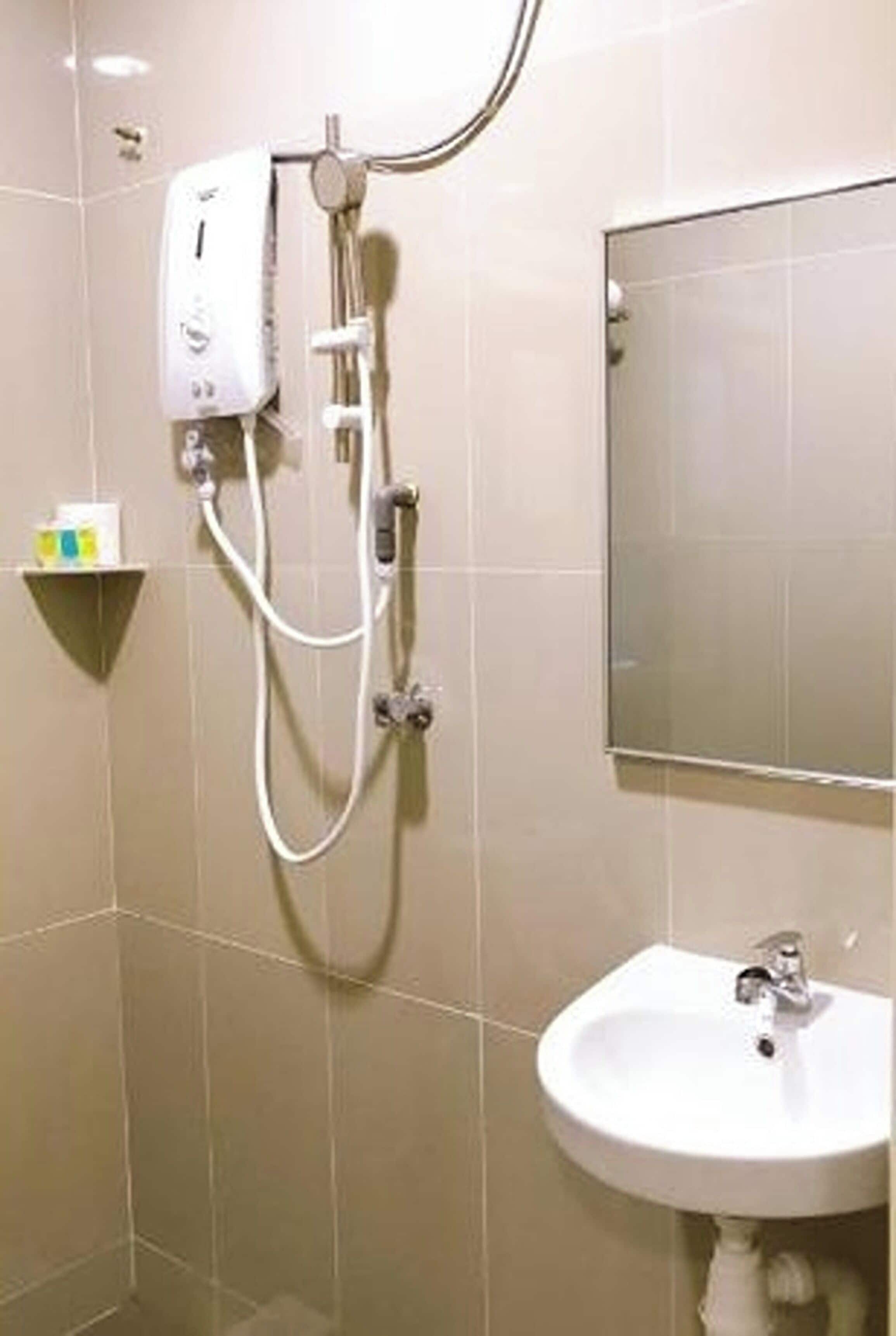 A bathroom with a shower, sink, and mirror.