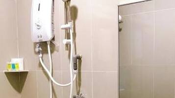 A bathroom with a shower, sink, and mirror.