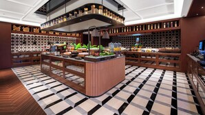 A modern interior with a central island, wooden shelving, and patterned flooring. - IntercityHotel Shanghai World Expo Hotel (Shanghai)