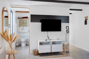 Un baño moderno con inodoro, lavamanos y espejo.