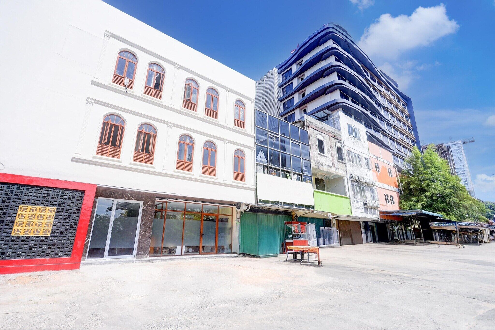A multi-story building with a modern design, featuring a glass facade and a mix of architectural styles.