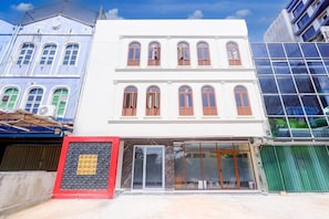 A multi-story building with arched windows and a glass entrance.